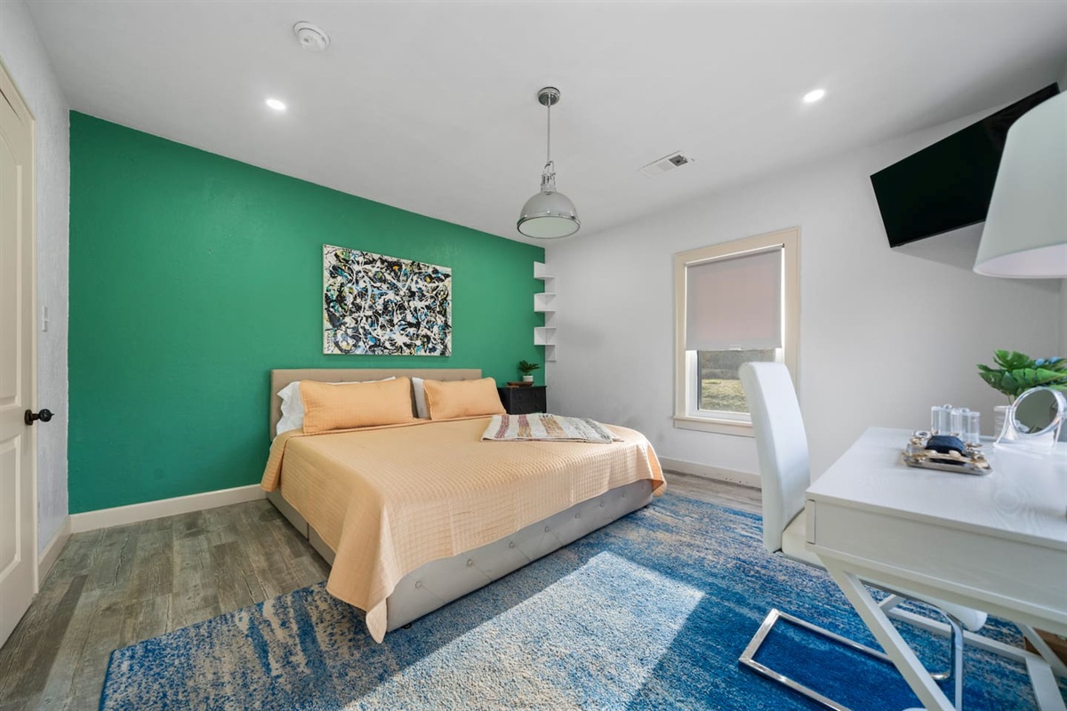 Bedroom Retreat: Bright walls and modern decor invite you to relax in style and comfort!