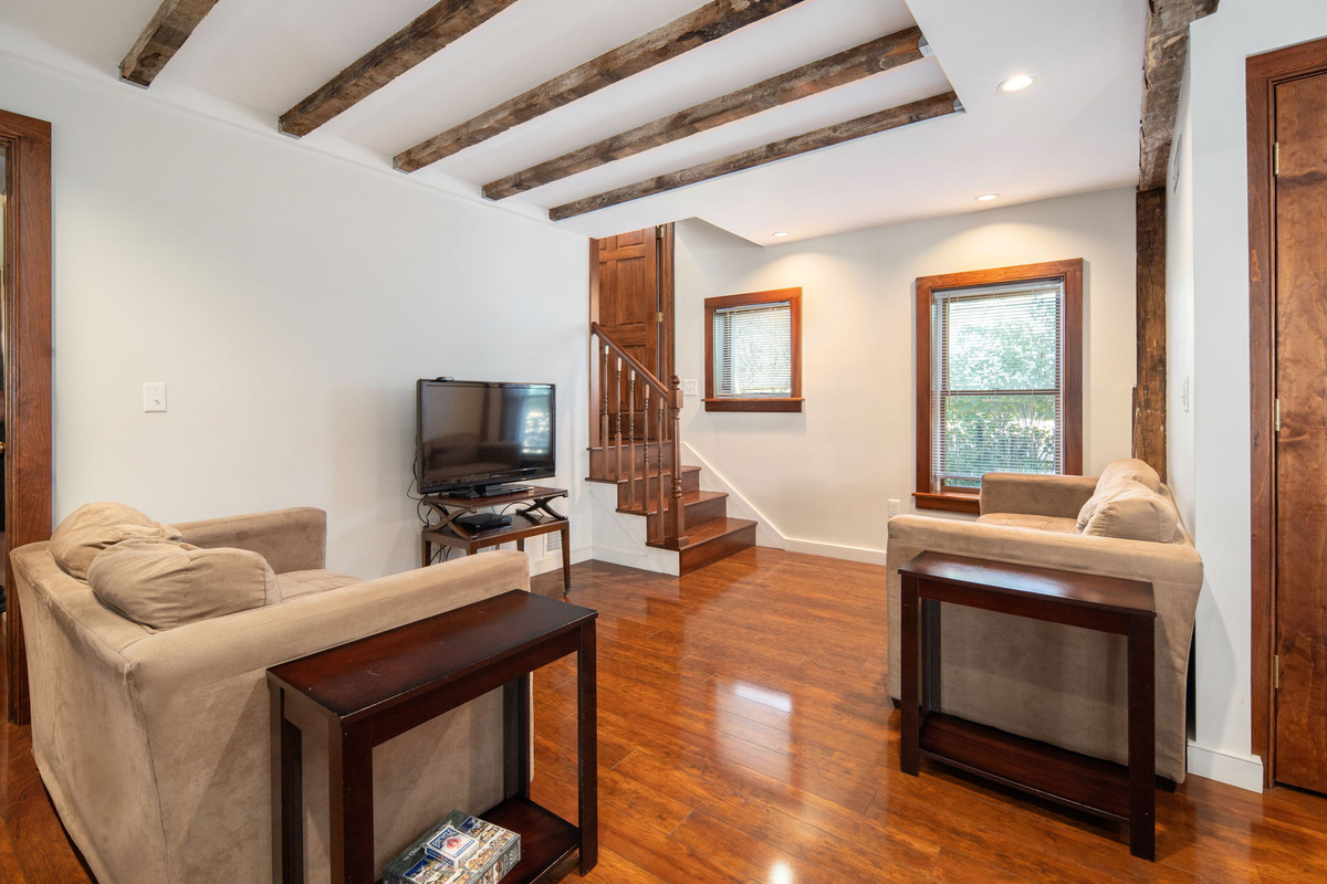 Exposed beams and comfortable seating make the living room an inviting place to relax.