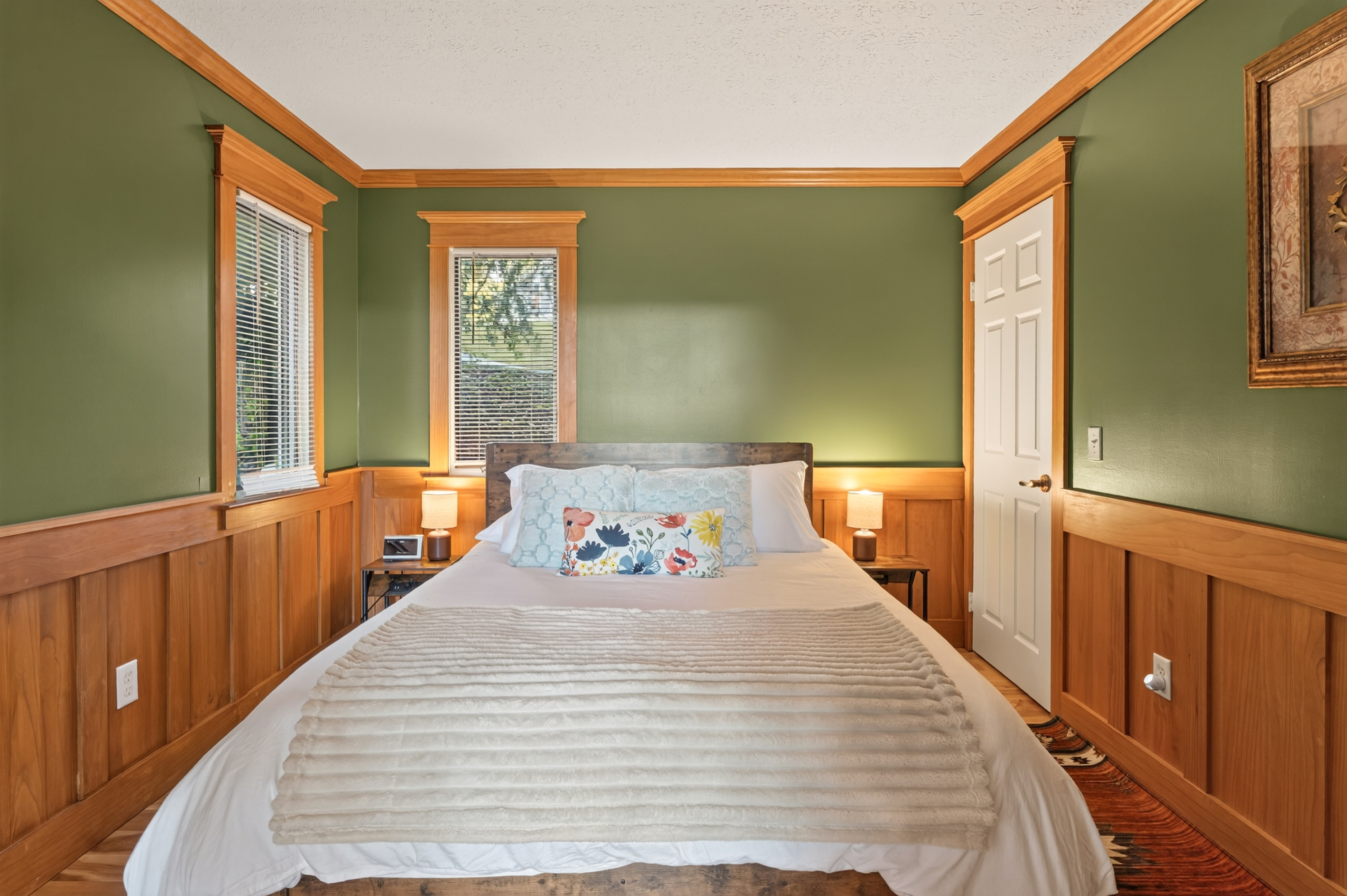 Green bedroom with wood-paneled walls