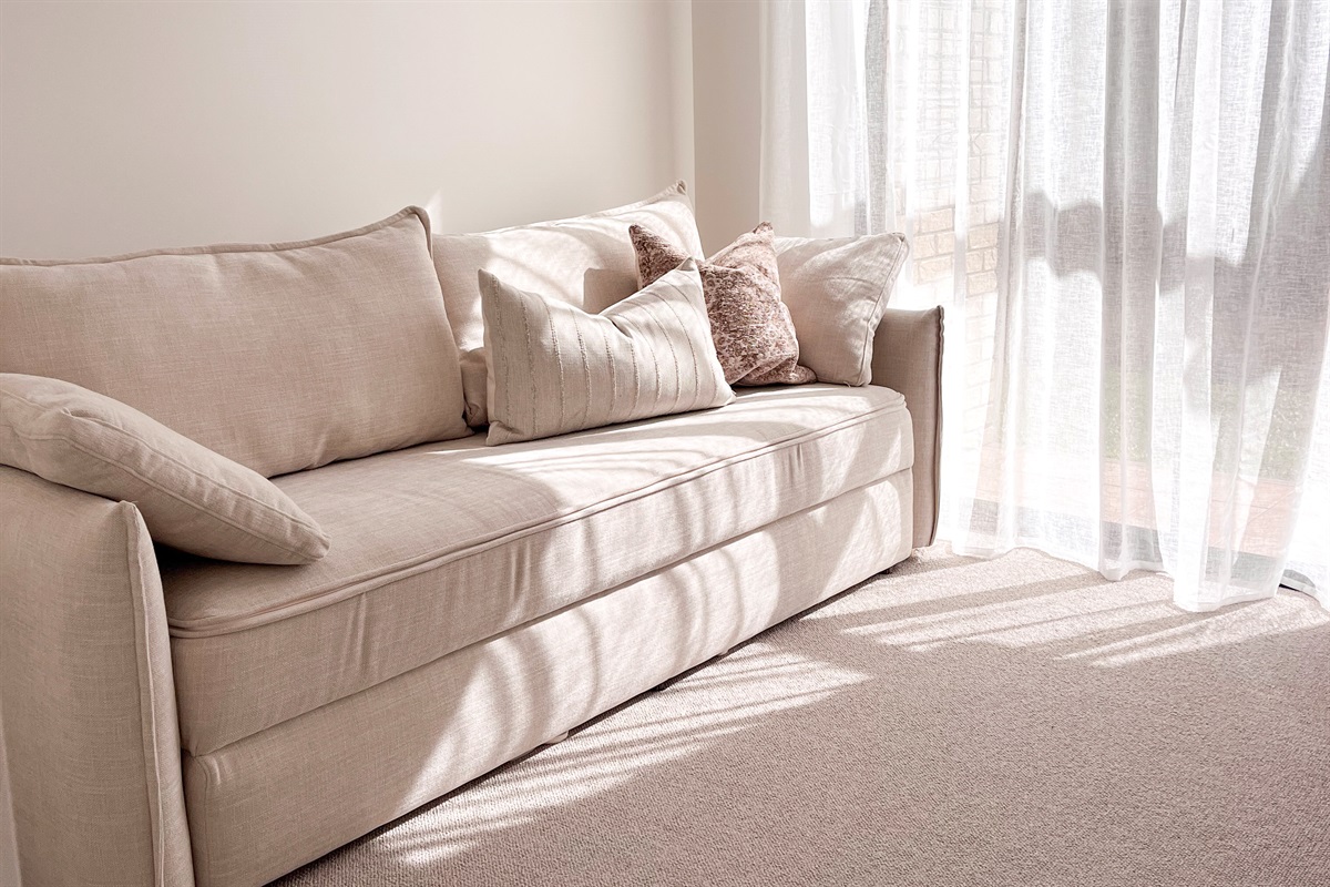 The double sofa bed adds a flexible fourth sleeping space, with soft cushions and room to move beside the window.