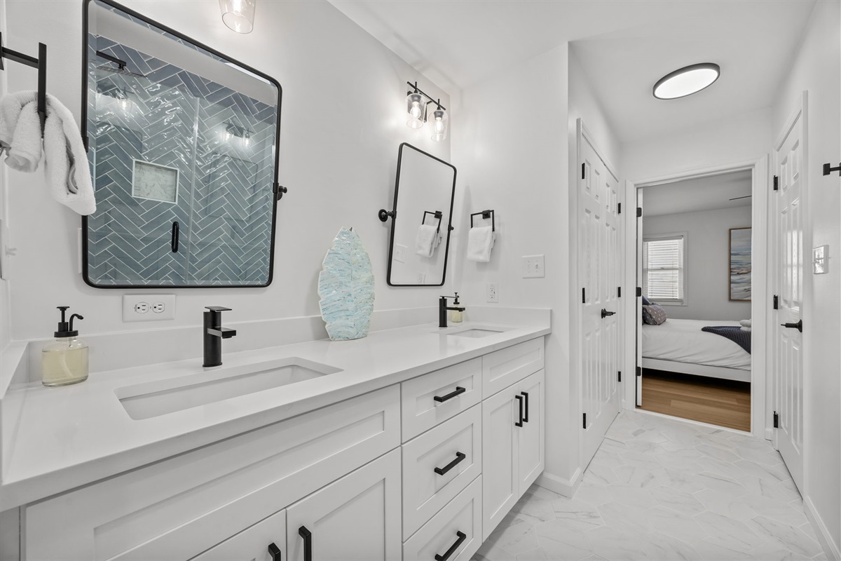 Walk-in shower with custom tile and glass enclosure in 1st floor master bathroom