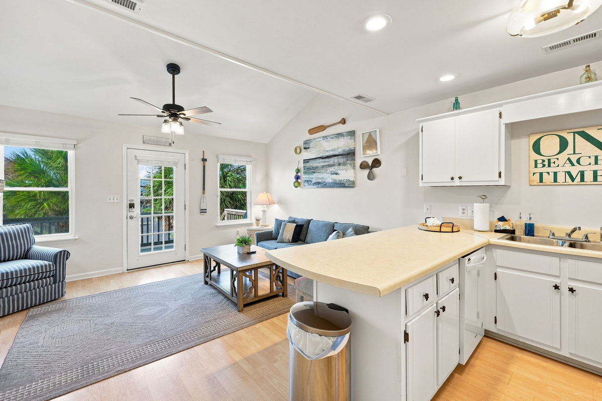 Flow effortlessly from the cozy living area to the kitchen, designed for easy beachside living.