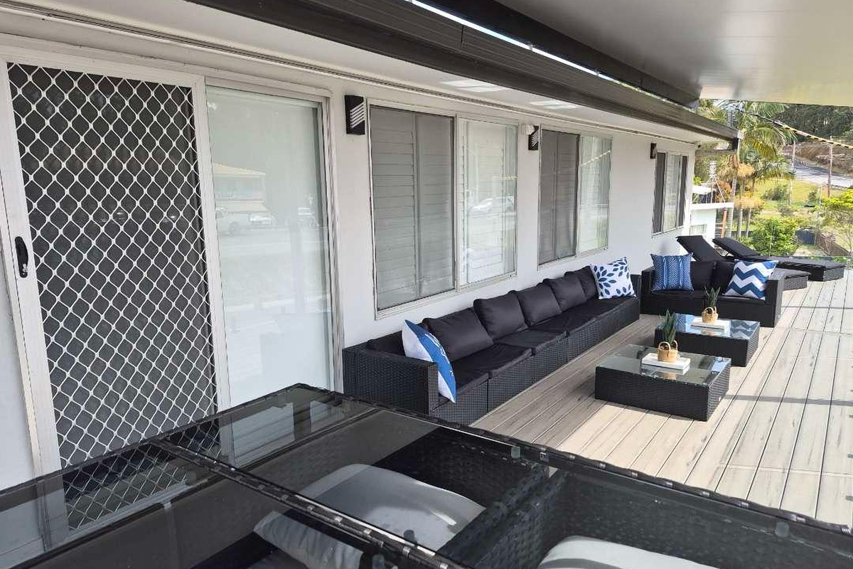 The upstairs front balcony adds one of Skye’s Beach House’s key outdoor areas, positioned toward the Malua Bay Beach side of the property.