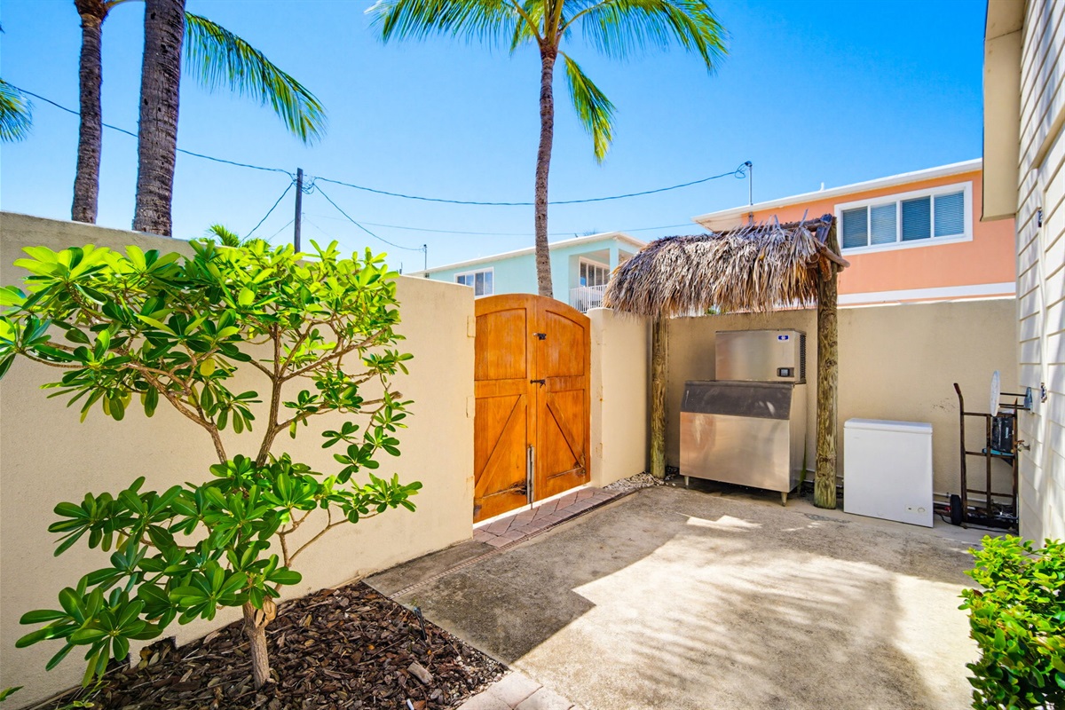 Enjoy the commercial ice machice, and deep freeze cooler, located inside the private yard enclosed with a privacy wall.