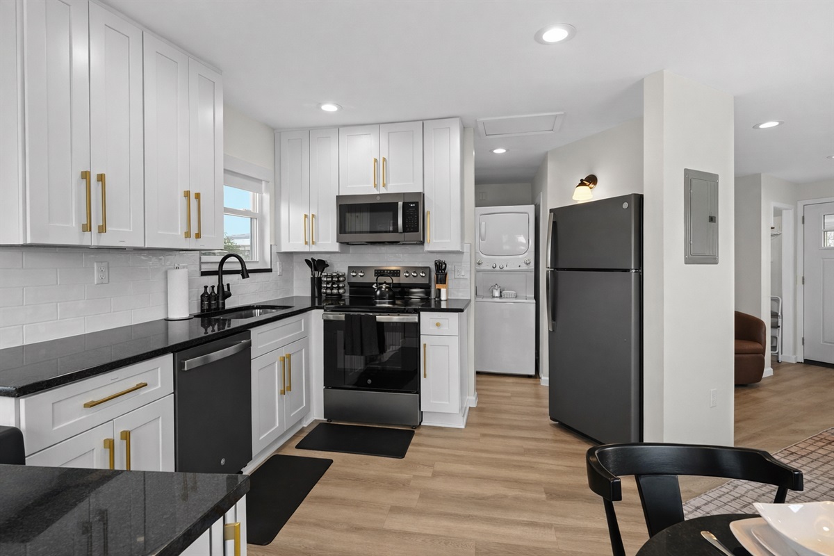 Spacious, modern kitchen with full-size appliances, ample storage, and in-unit laundry—bright, functional, and designed for easy, comfortable stays.