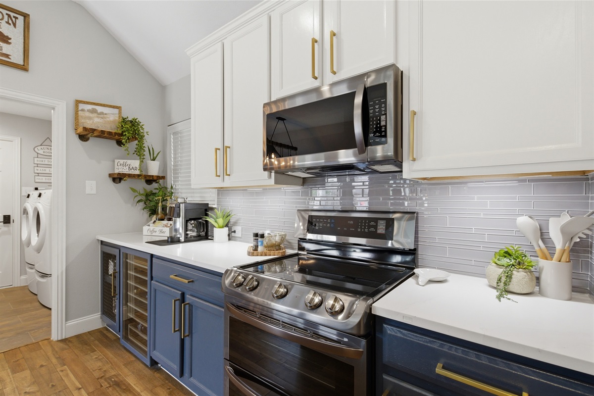LG Electric Stove with Double Oven and an over-range LG Microwave. Cooking basics, dishes, and silverware all on hand for the whole group.
