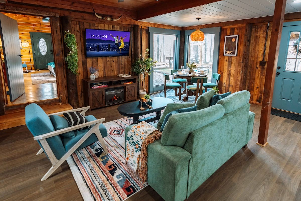 Cinema nights meets woodland vibes in our open-concept 600 sq. ft. living suite