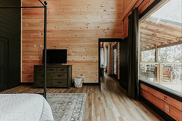 Wake up to soft morning light and peaceful forest views from this cozy, sunlit bedroom