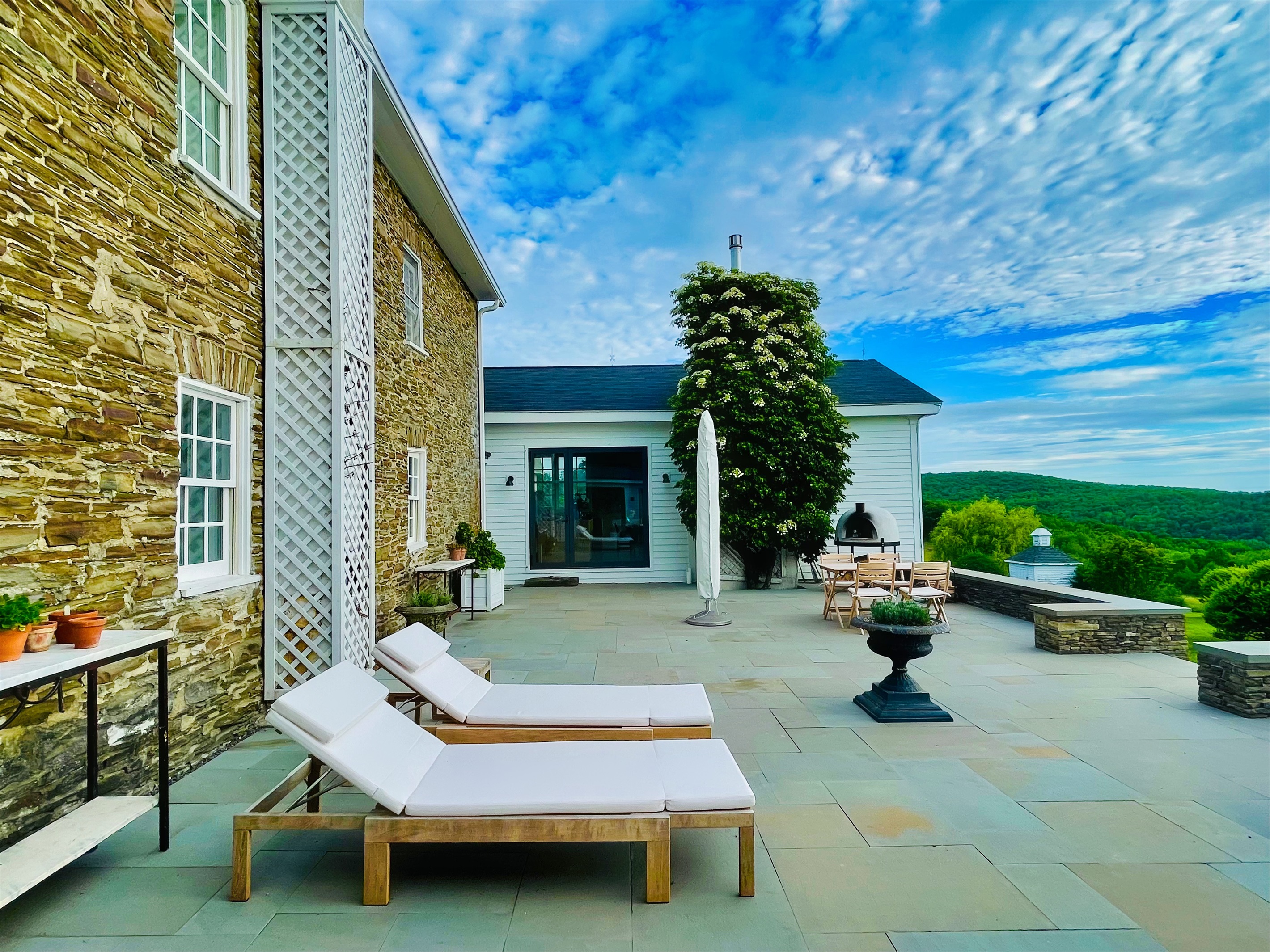 Hawk Field House - Bluestone patio with custom stone pizza oven, outdoor seating and lounging.