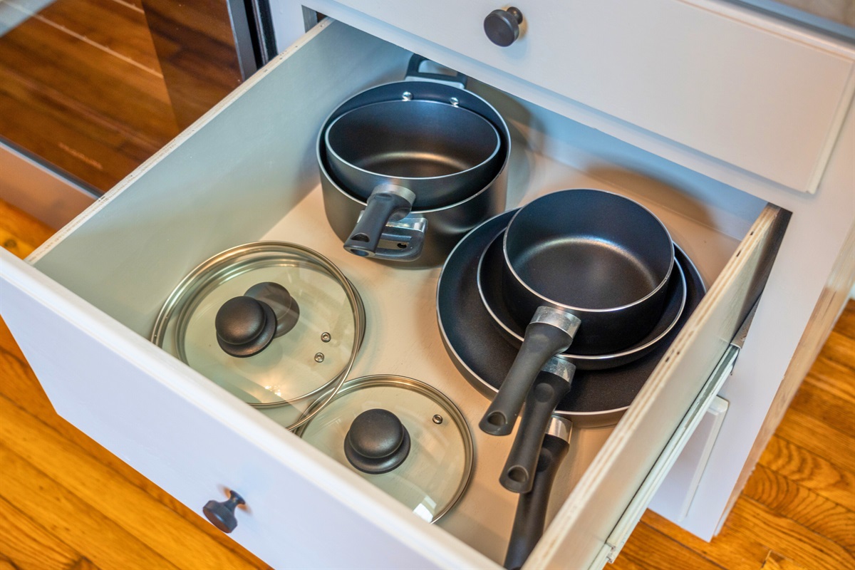 A neatly organized drawer with pots and pans ensures you’ll have all the tools you need for cooking up your favorite meals.
