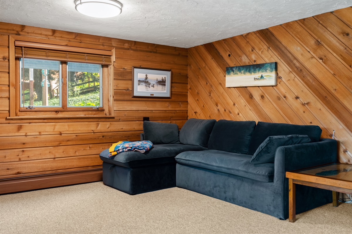 Lower-level lounge with sectional sofa and wood accents