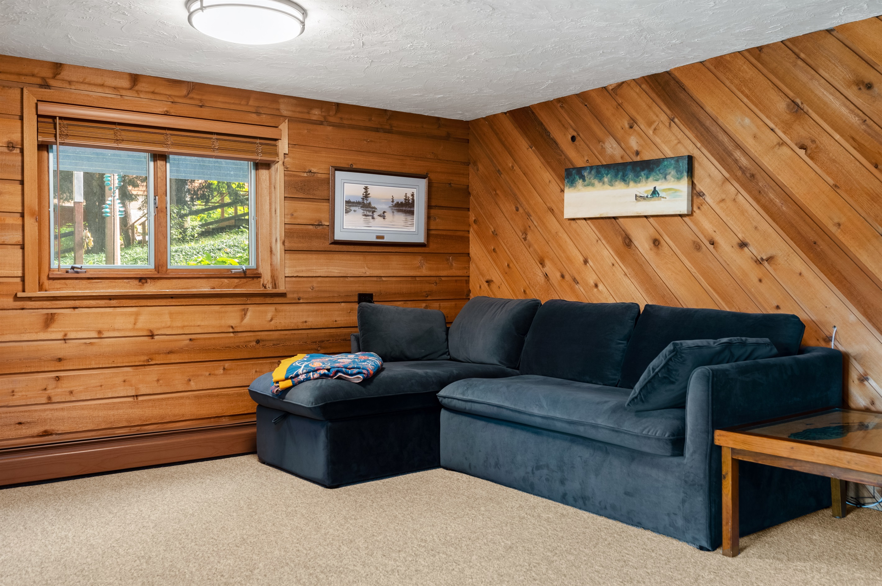 Lower-level lounge with sectional sofa and wood accents