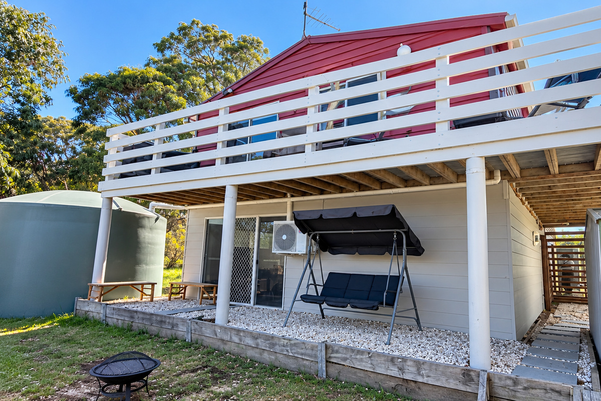 Carlenes Getaway offers plenty of outdoor space to enjoy, with a backyard, covered swing seat and spacious upper deck.
