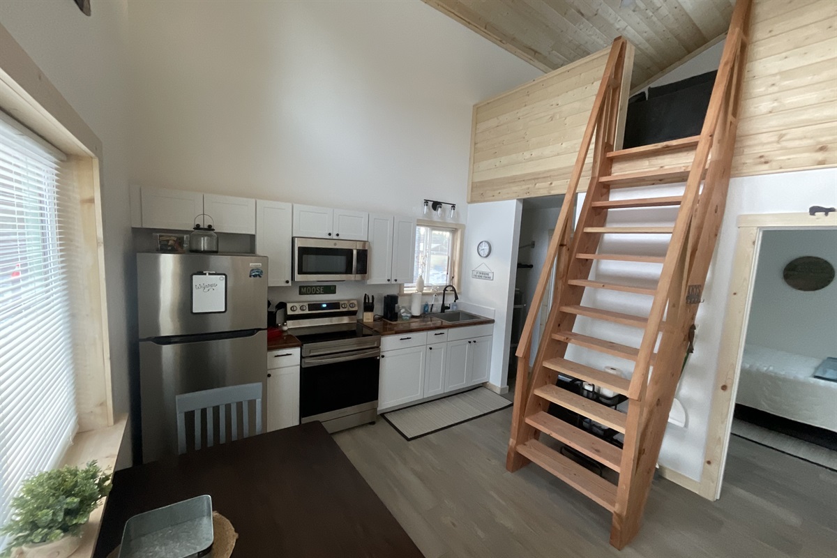 Main floor area.  Bedroom is to the right front.  Bathroom and laundry are to the right rear.  Ships ladder access to the loft living area and additional sleeping space.