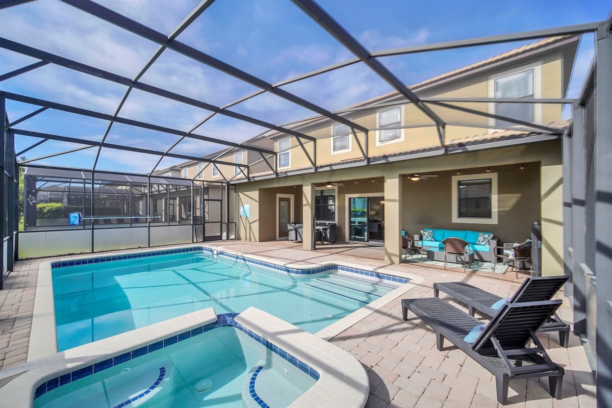 Large Pool Area with Jacuzzi. Lounge area and outdoor dining area.