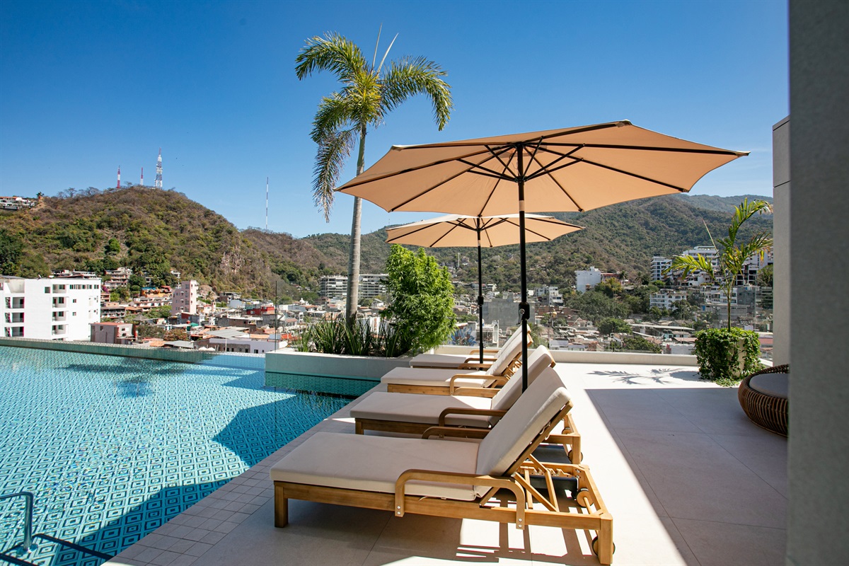 A peaceful rooftop retreat—stretch out on poolside loungers and soak up the sun in pure relaxation.