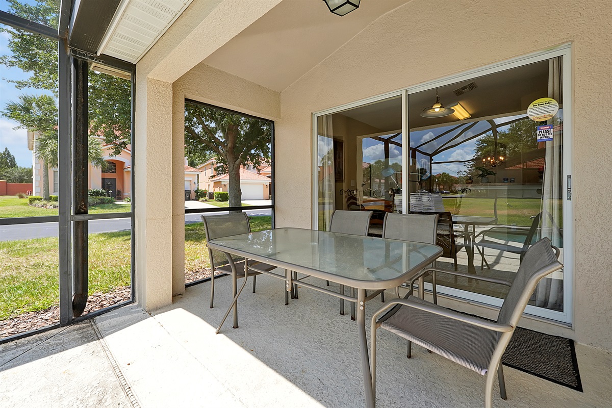 Florida living at its best: Covered patio overlooking the private pool 