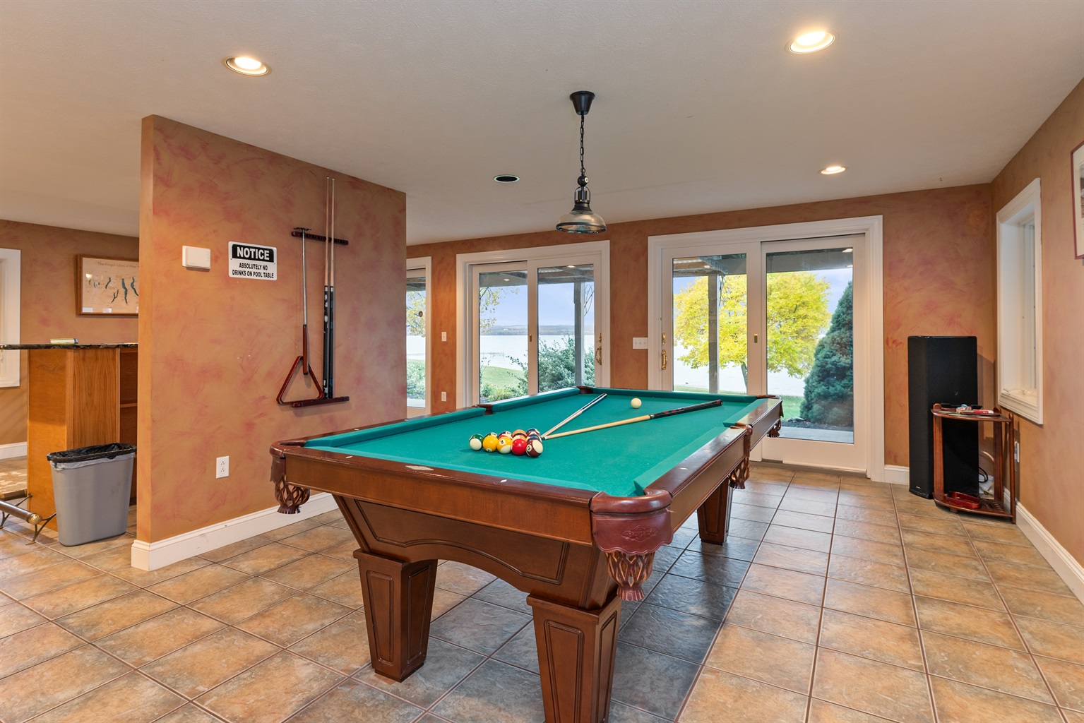 Lower level game area complete with a pool table and darts