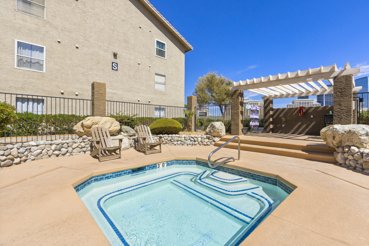 Shared hot tub area with lounge chairs