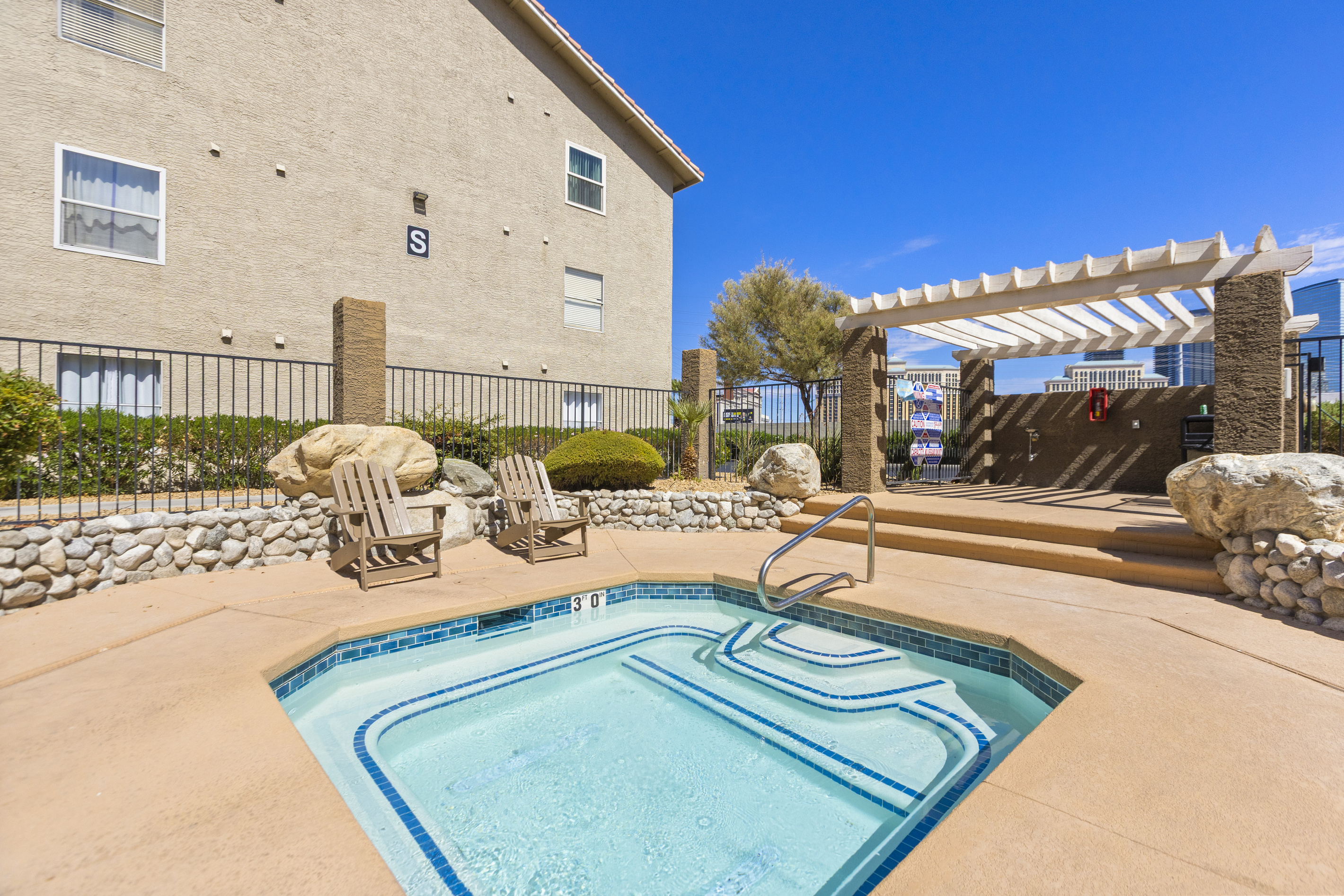 Shared hot tub area with lounge chairs