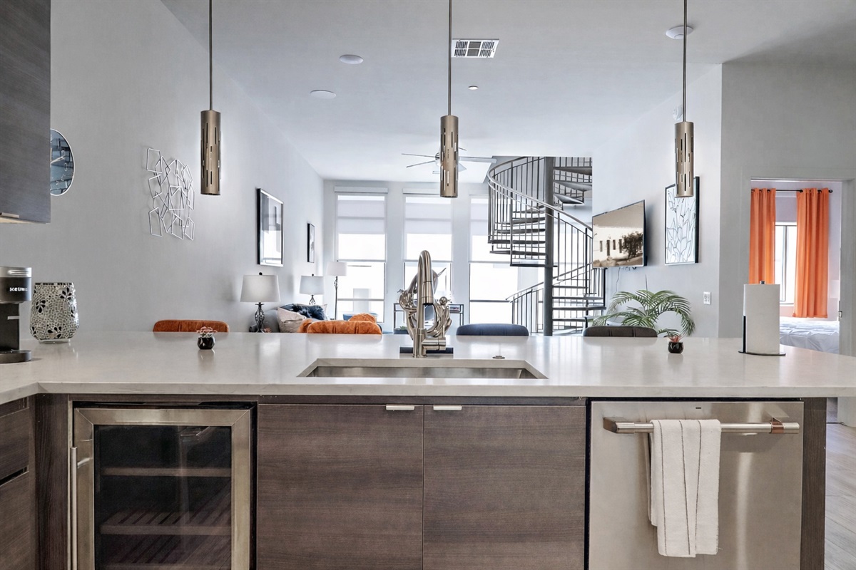 Fully equipped kitchen with spacious counter, modern appliances, and dining chairs for convenient in-kitchen meals or casual dining. Perfect for cooking, gathering, and everyday comfort during your stay.