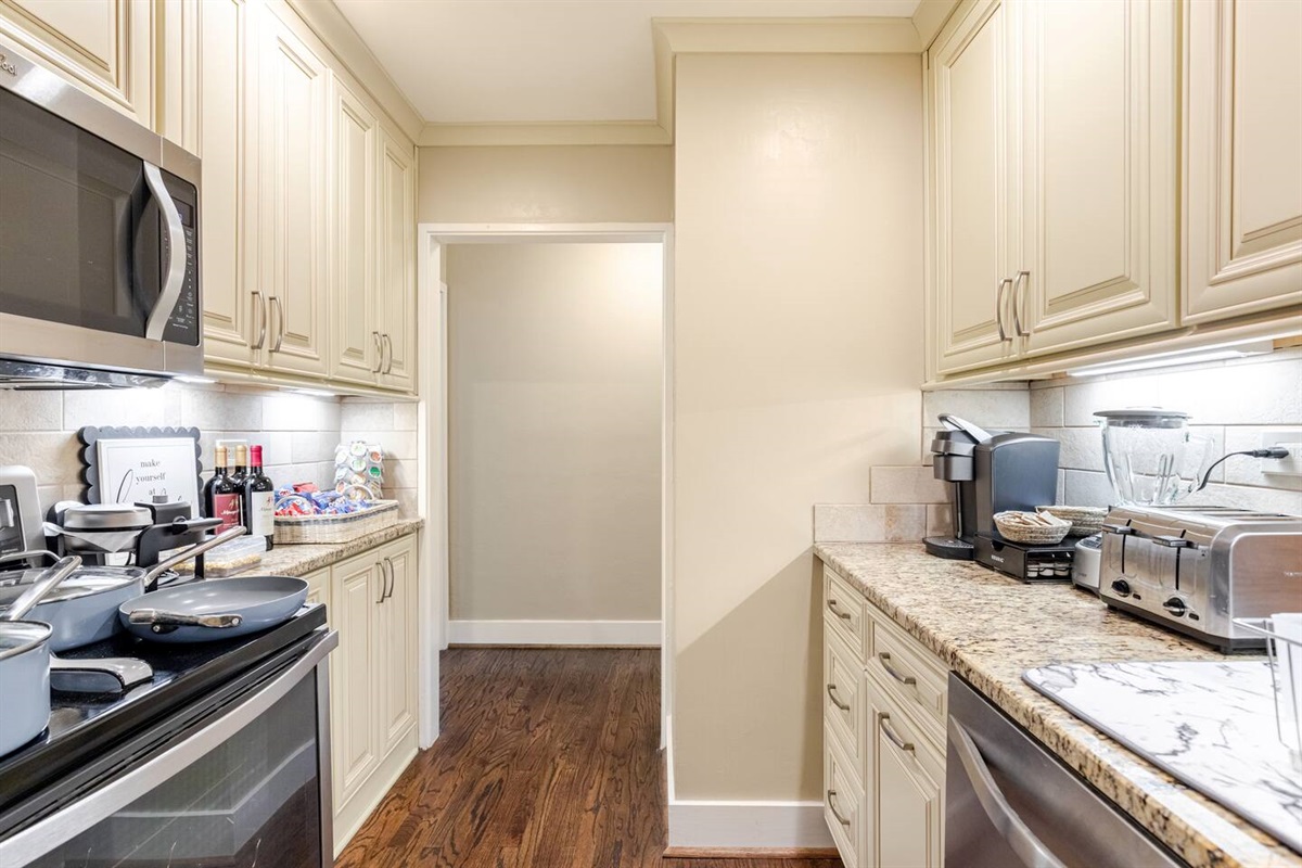 Kitchen w/ generous cabinetry & stainless appliances for home-style cooking.