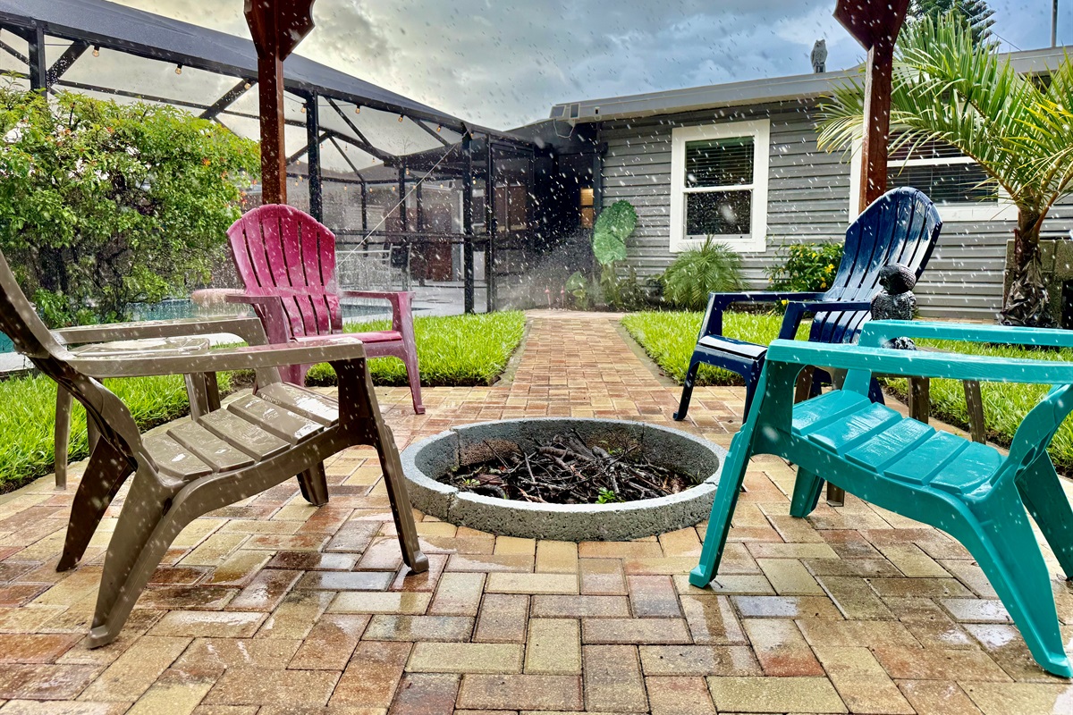 Pull up a colorful Adirondack chair, light the fire, and unwind beneath the open beams of this stunning backyard retreat.