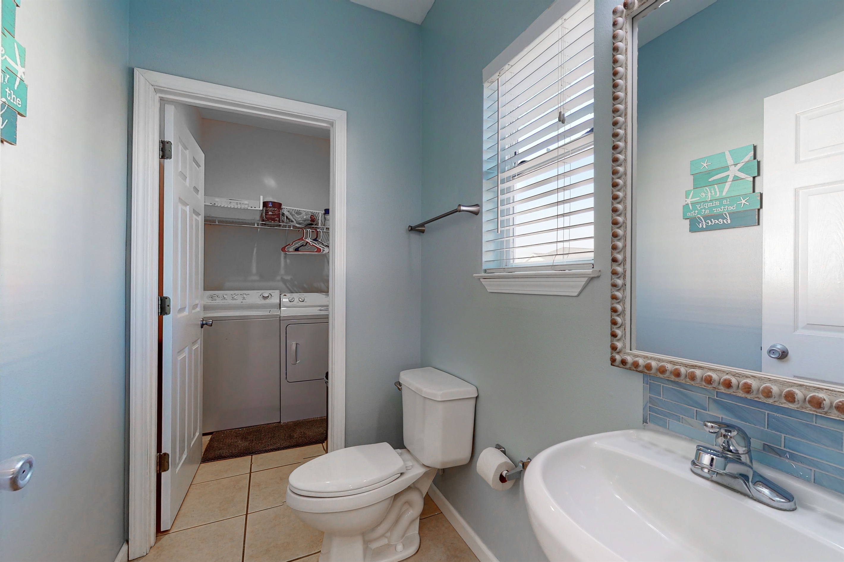 Half bathroom leads to washer and dryer room