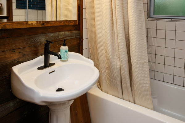 A character-filled bath with reclaimed wood accents and patterned tile.