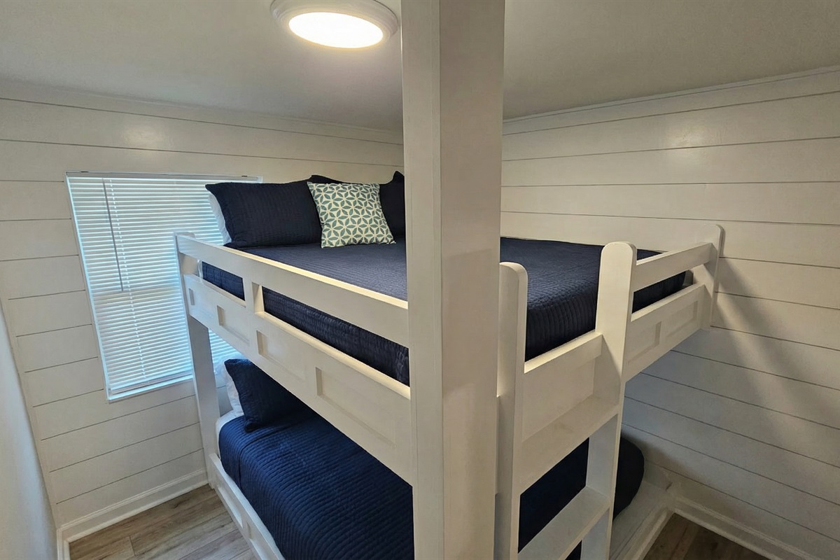 Built in - custom queen over queen bunks.  Each bunk has its own light and cubby to charge electronics
