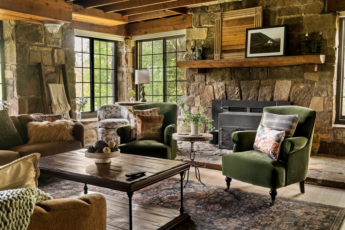 Gather around the stone fireplace (decorative only) in this warm and inviting living space.