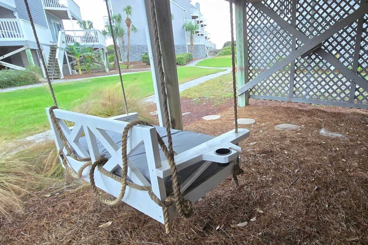 Catch the afternoon Gulf breeze from this angle of the covered swing &mdash; there is always a spot to land at any hour of the day.