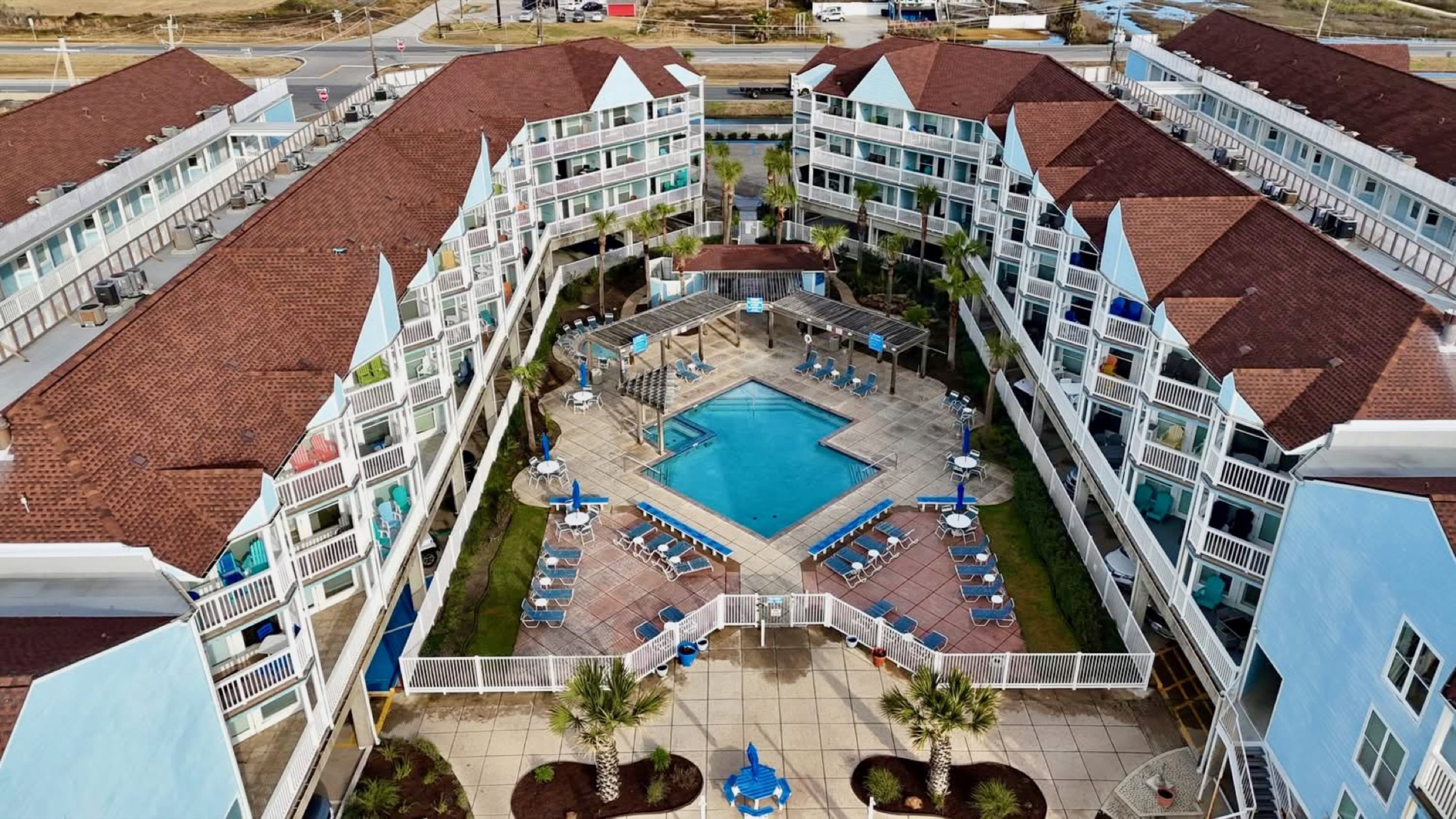 Bird’s-eye view of your beachfront resort—private balconies, heated pools, and seamless beach access on Galveston’s peaceful West End.