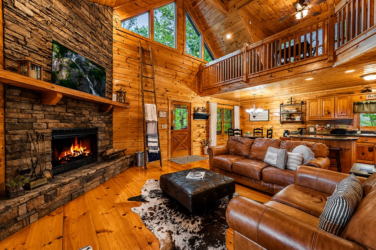 The seamless flow of the open-concept living, dining, and kitchen areas sets the stage for memorable moments shared around a crackling fire or leisurely meals savored while soaking in the captivating panoramic views through expansive single-paned French do