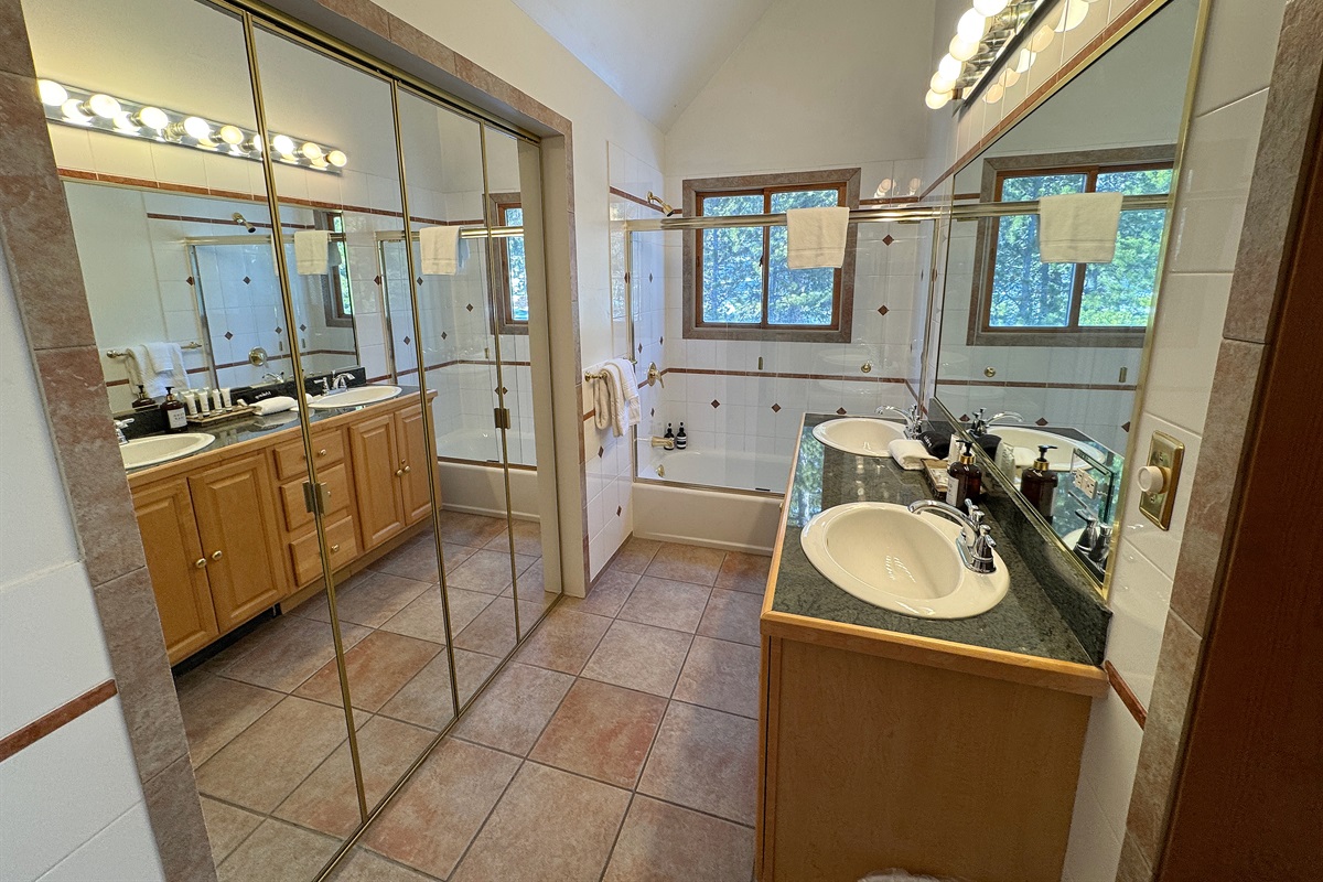 Right side of primary bathroom with dual vanity sink and TWO showers