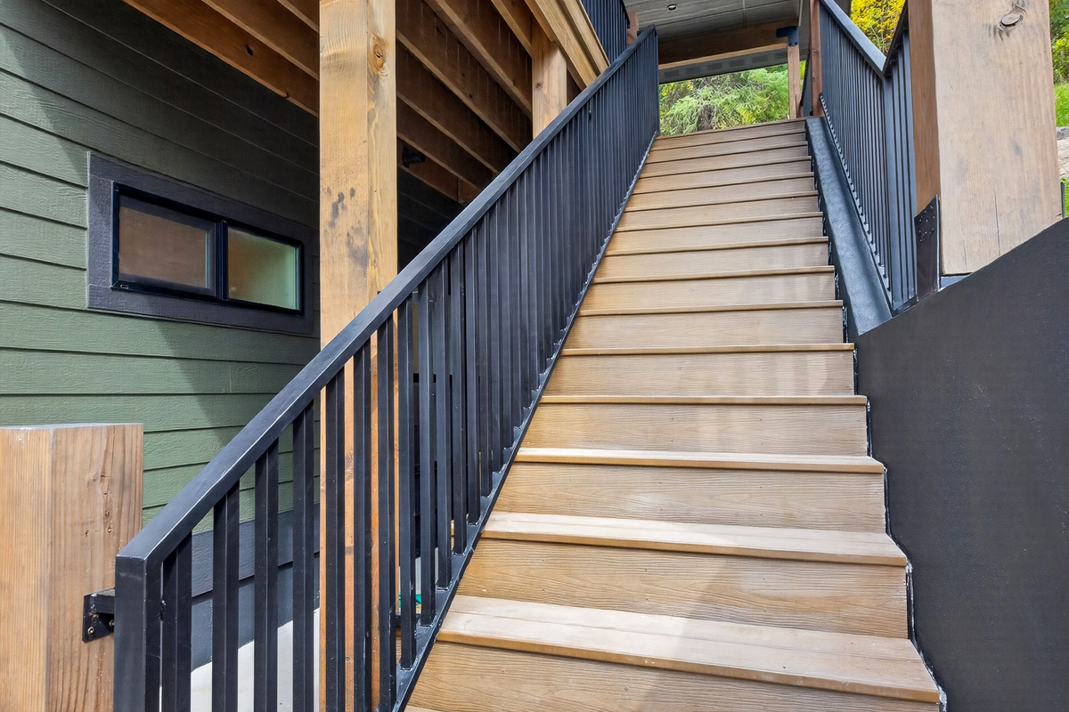 This is the stairway to the top floor, including lots of deck space and a second exterior entrance into the second primary suite.