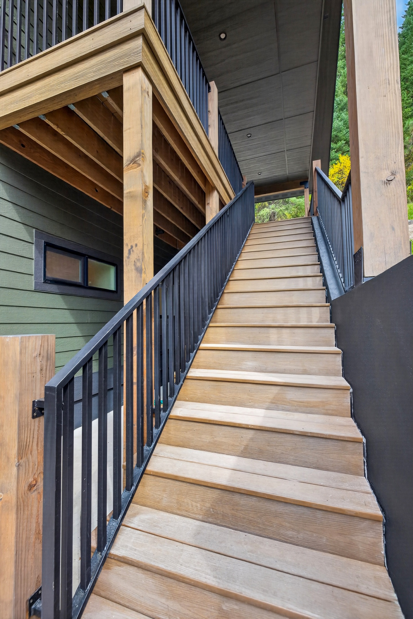 This is the stairway to the top floor, including lots of deck space and a second exterior entrance into the second primary suite.