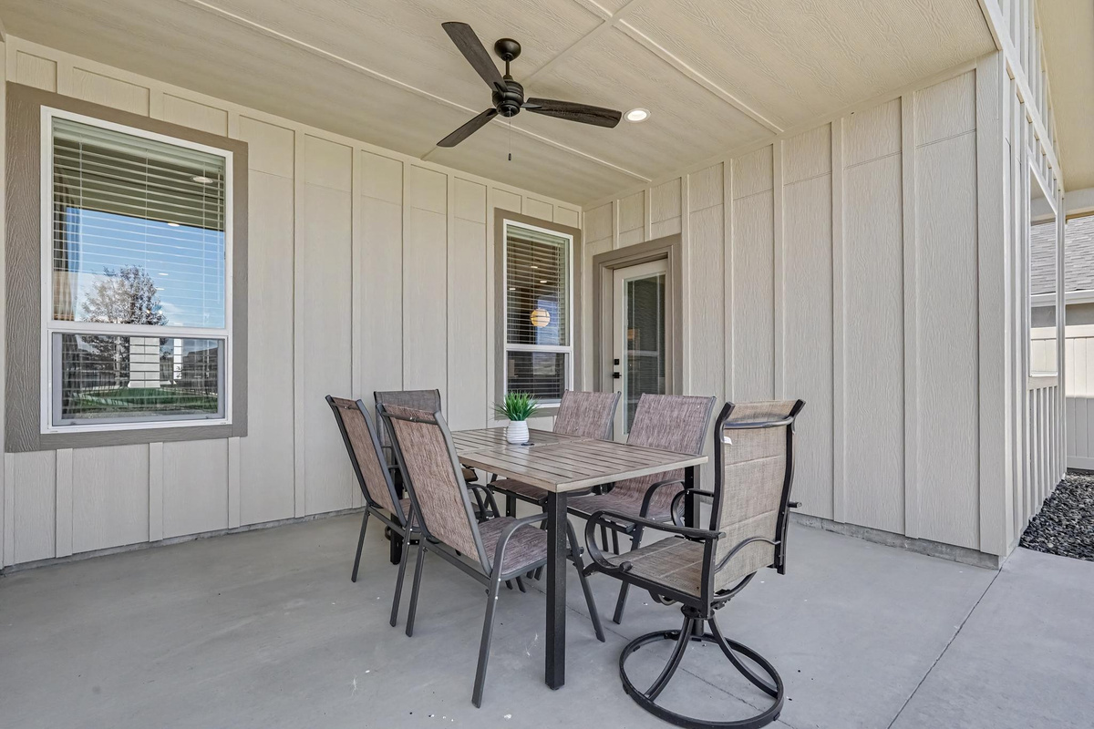 Enjoy outdoor dining at the shaded patio table, the perfect spot to relax and enjoy meals on warm days.