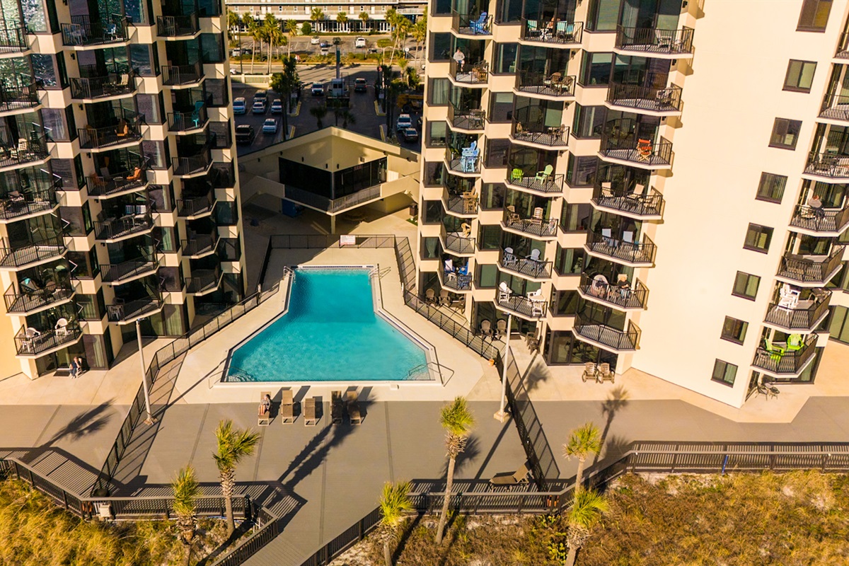 Sunbird's main pool w/private gated beach access — no streets to cross, just sand between your toes.