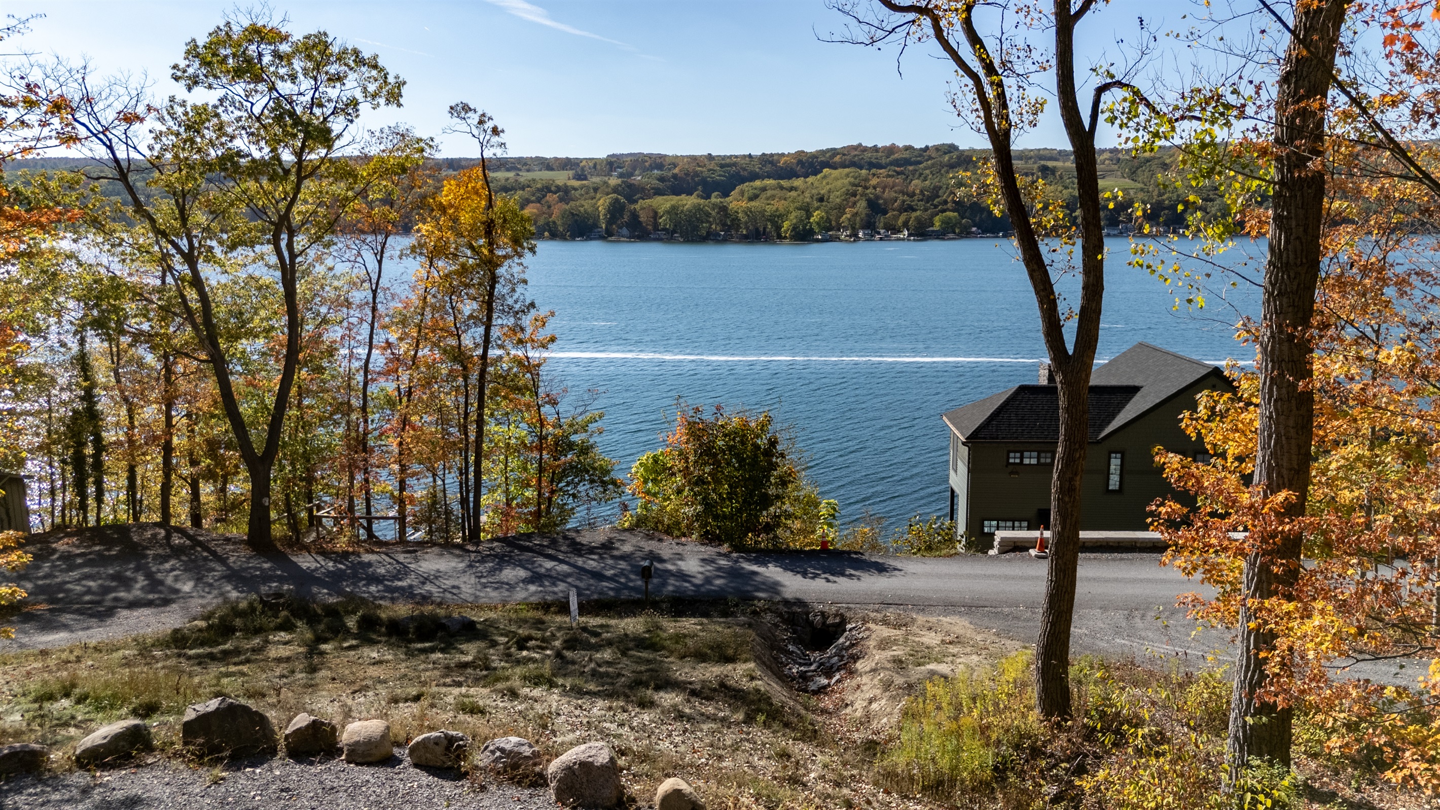 Lakefront view across trees and shoreline — serene water retreat.