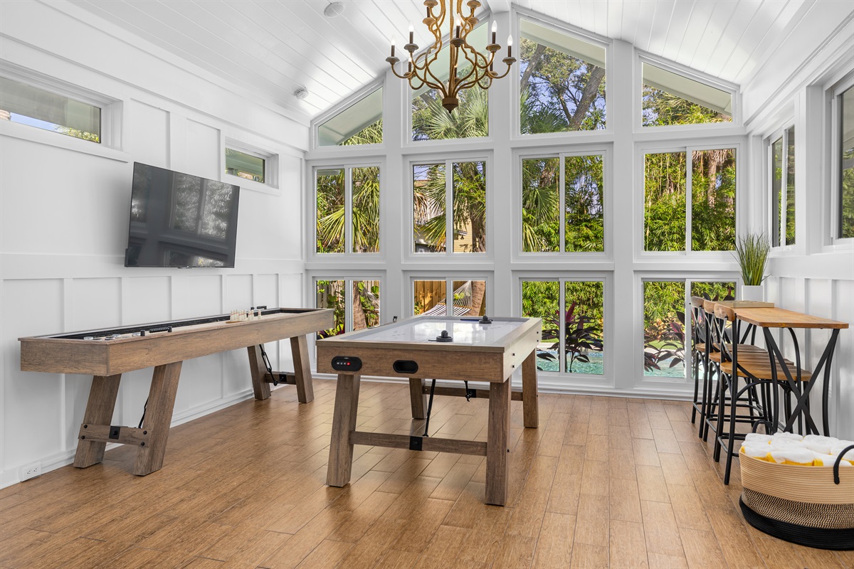 Sun-filled entertainment room with panoramic views, smart TV, air hockey, and shuffleboard - your group's favorite hangout spot