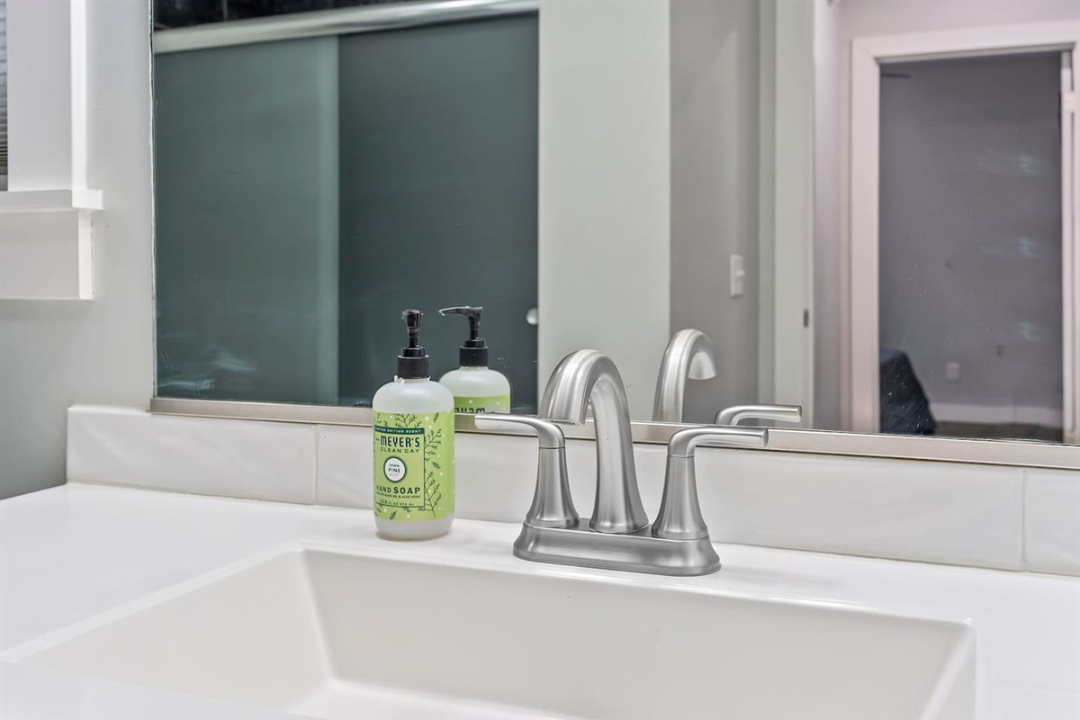 Vanity detail with sleek fixtures, large mirror, and thoughtful touches for a comfortable stay.