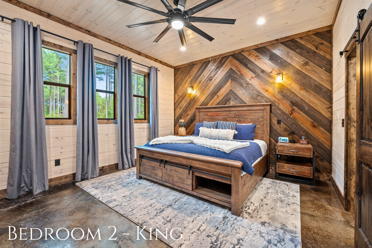 This serene king bedroom, with wood accents and cozy furnishings, is a peaceful retreat after a day of adventure.