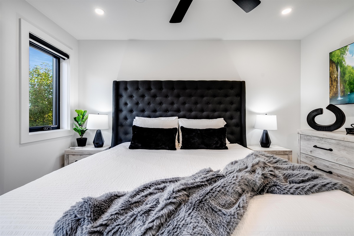 King Bedroom with Sleek nightstands with modern lamps provide functional style.