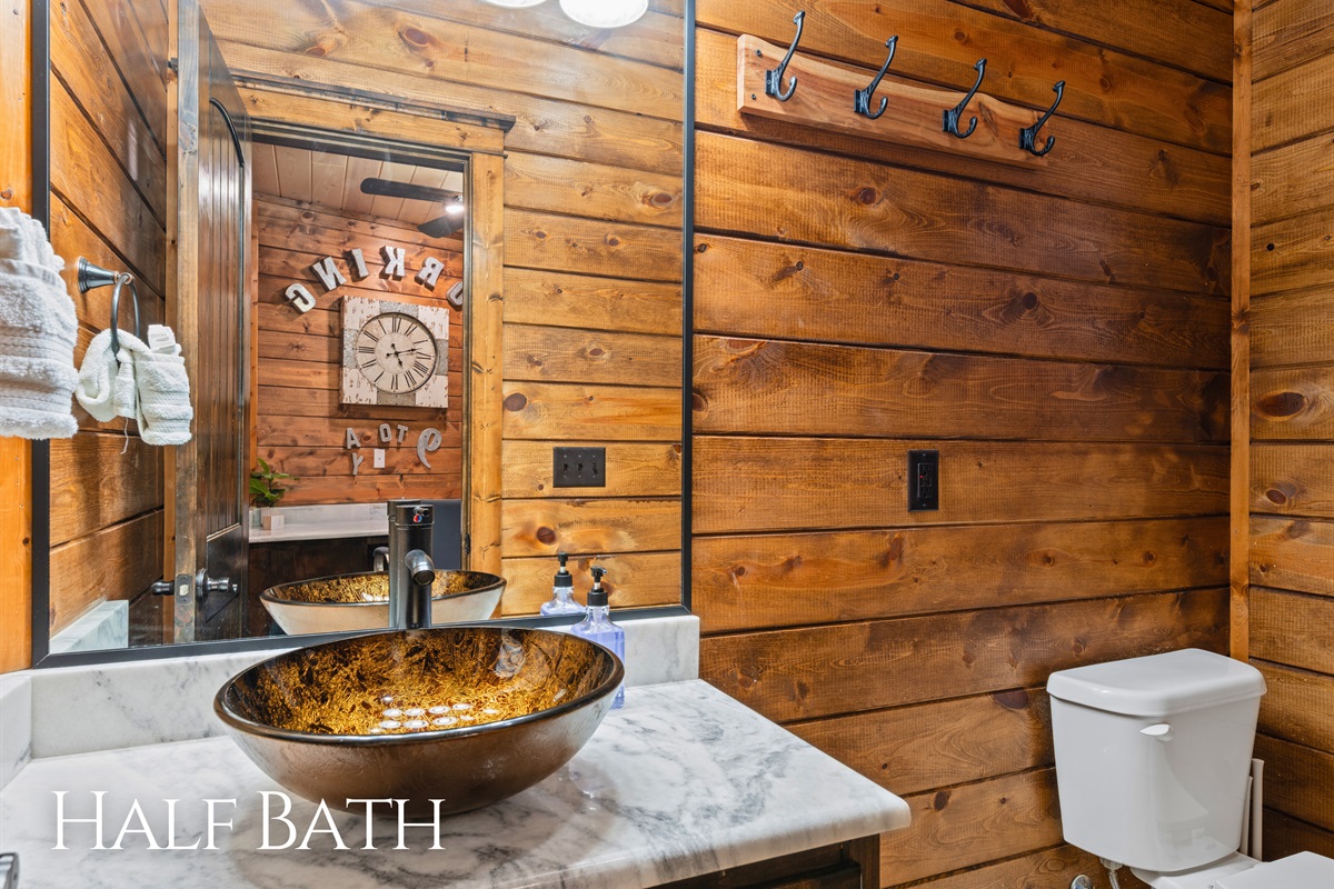 A stylish half bath adds convenience and charm with rustic finishes and unique design details.