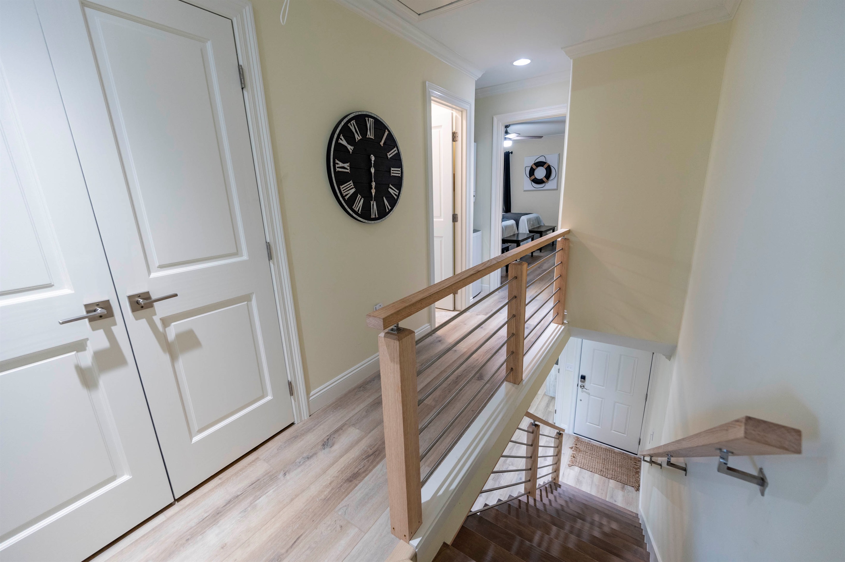 Bright and welcoming hallway with modern railings and cozy coastal vibes.