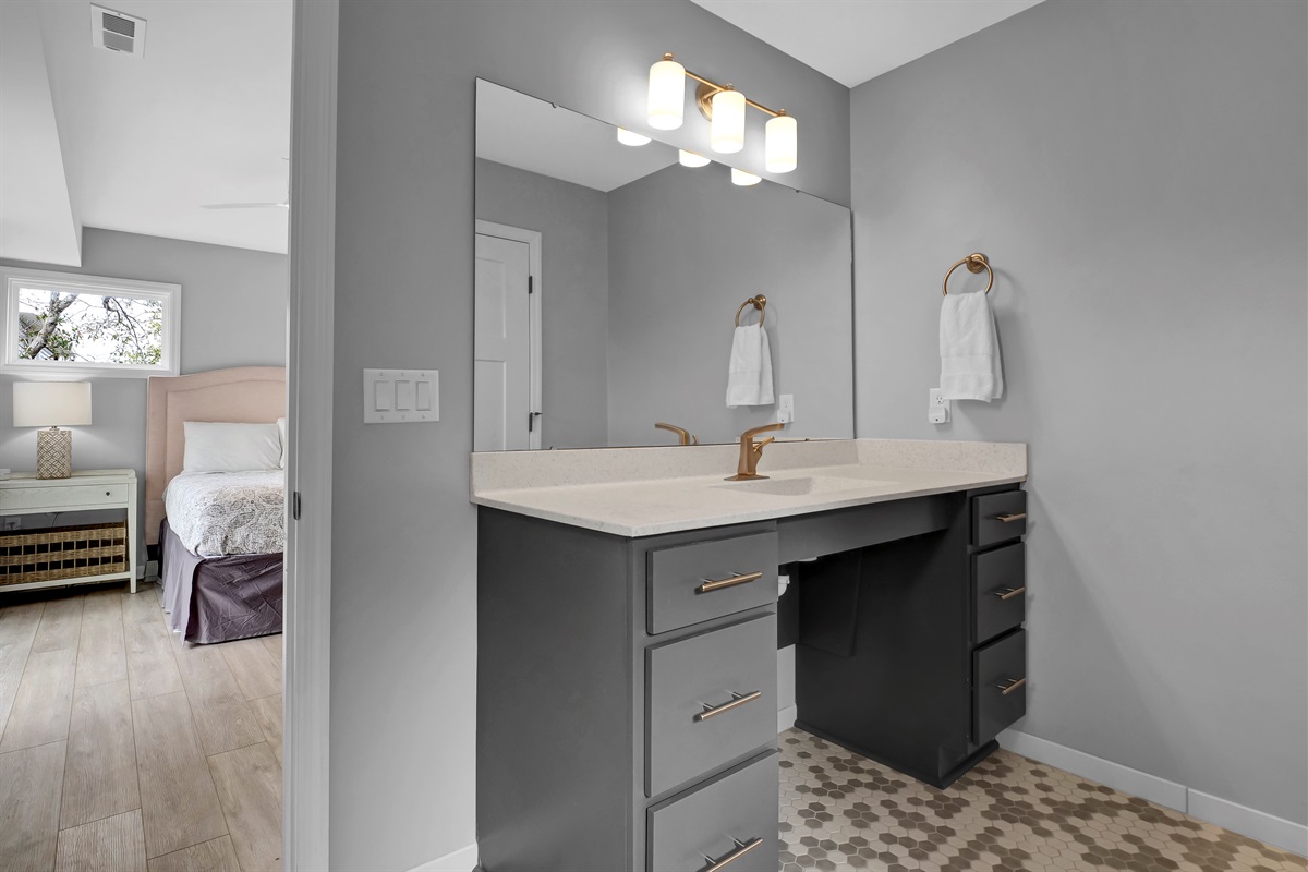 This thoughtfully designed bathroom includes a roll-under sink and vanity.