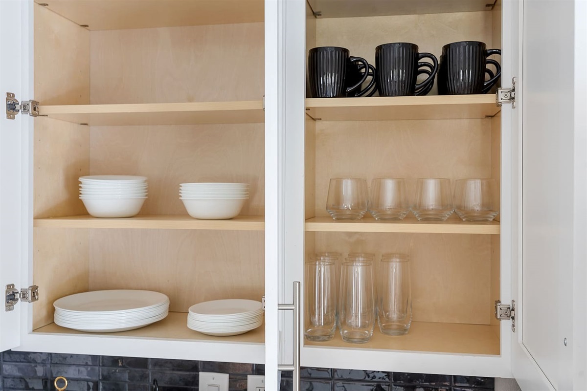 Access all the essentials with neatly organized cabinets stocked with dishes, mugs, and glassware. This setup ensures a convenient and comfortable stay.