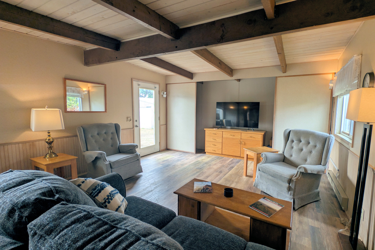 large living room with door to back deck/yard