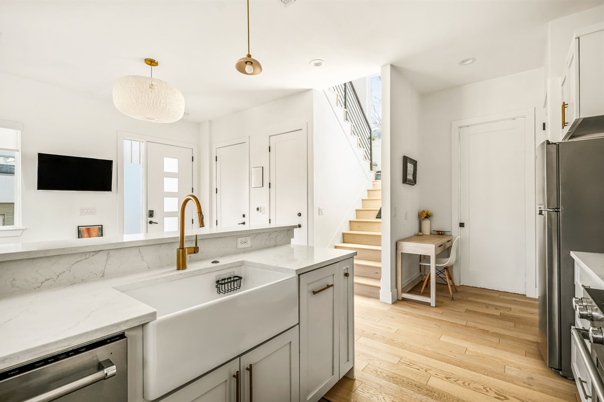 Bright, modern kitchen with quartz countertops and an oversized island